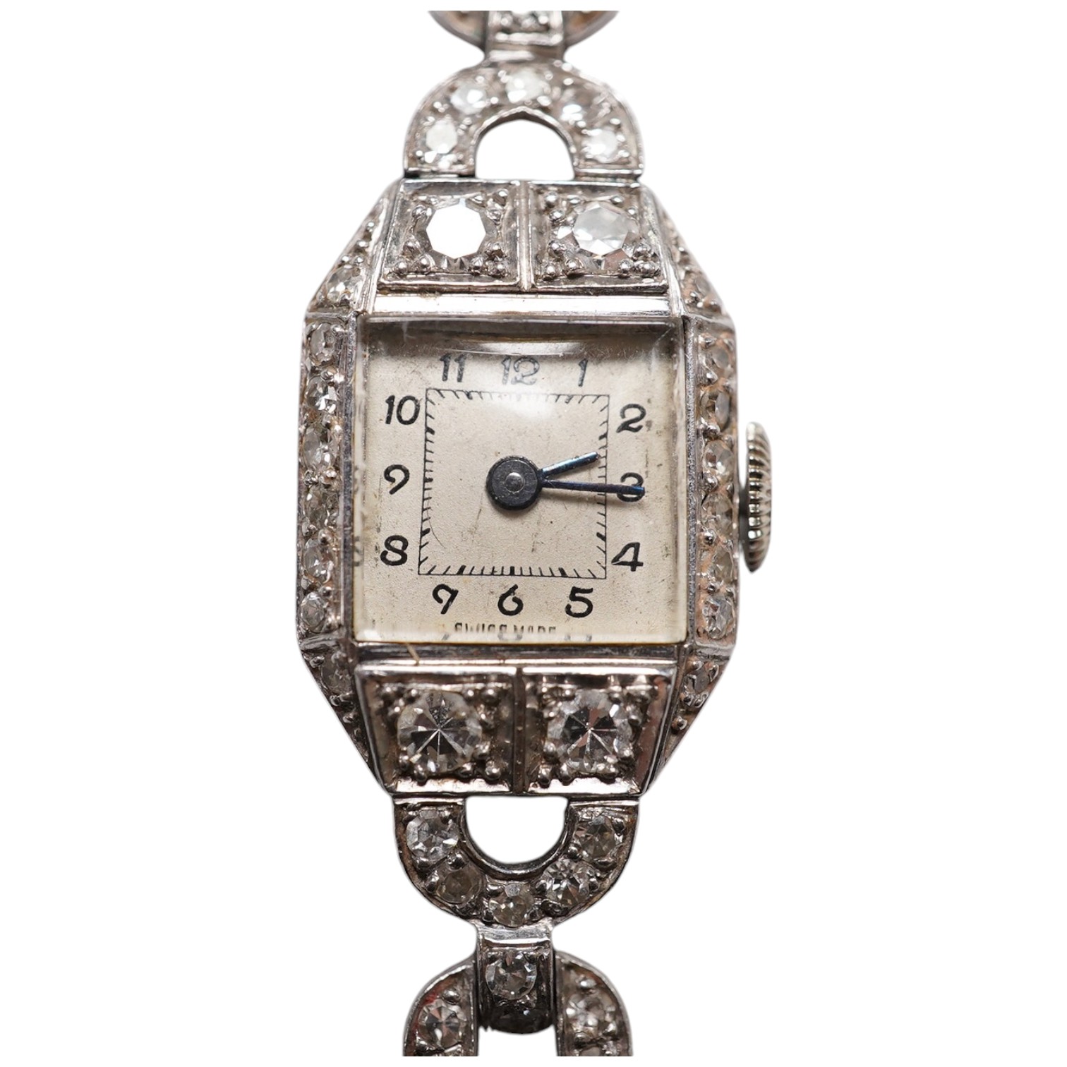 A lady's 1950's white metal and diamond cluster set manual wind cocktail watch, on a 9ct white gold bracelet, overall length 17.5cm, gross weight 17.1 grams. Condition - fair